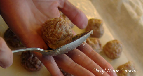 Rolling the minced meat mixture into balls using a spoon and the palm of your hand