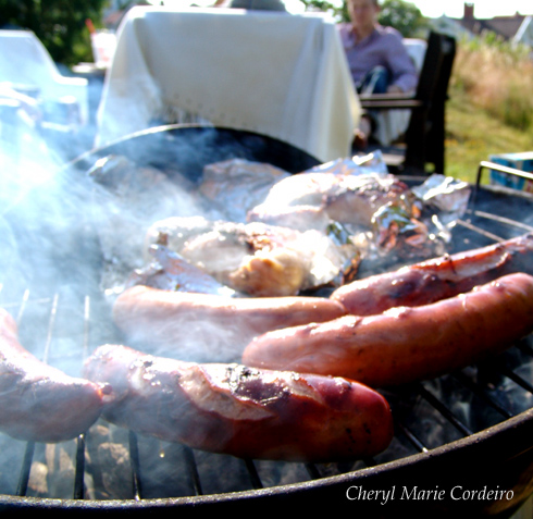 German sausages and chicken on barbeque pit