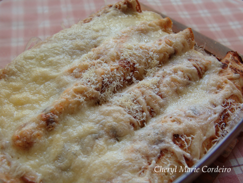 Swedish mushroom crepes, topped with parmesan cheese, baked