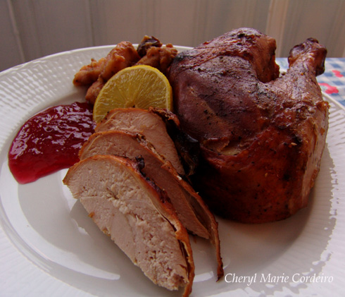 Roast turkey served with red currant jam and slice of lemon on a platter