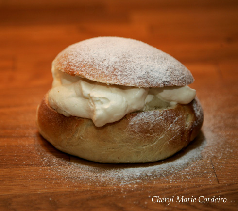 Hembakad semla; homebaked semla filled with marzipan and whipped cream.