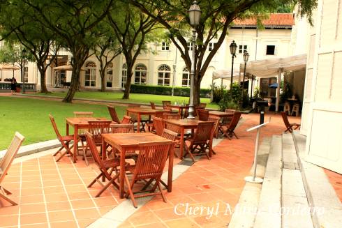 CHIJMES, tables and chairs in pockets of green.