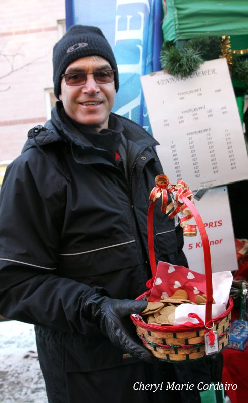 Giving away free pepparkakor at a lottery draw booth, Haga julmarknad, Sweden.