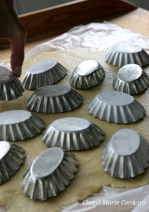 Mazariner tin forms on pastry dough.