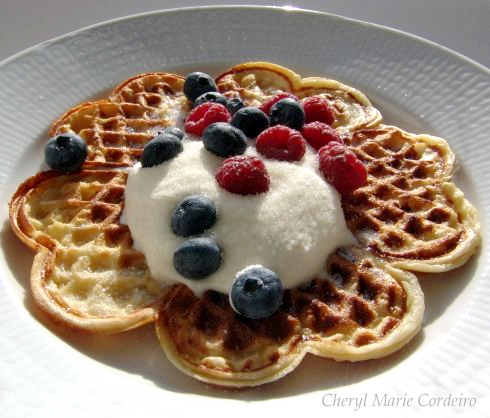 Waffle with whipped cream, blueberries and raspberries