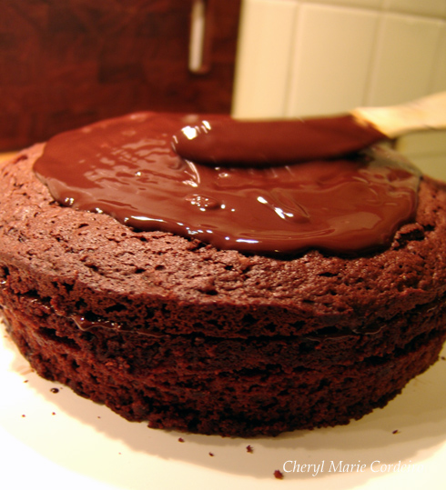 Covering chocolate cake with ganache