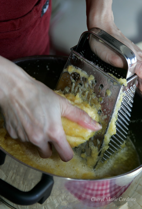 Grating the pineapples for pineapple jam, pineapple tarts, Singapore style