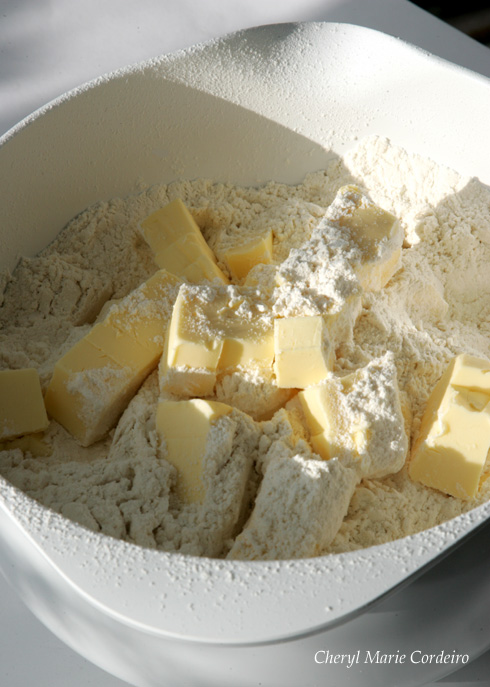Cubed butter in flour for short crust pastry in pineapple tarts, Singapore style