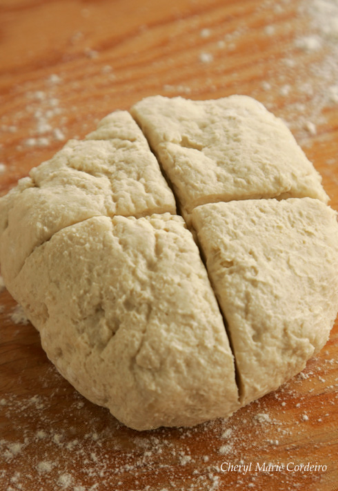 Puff pastry dough with a cross on top.