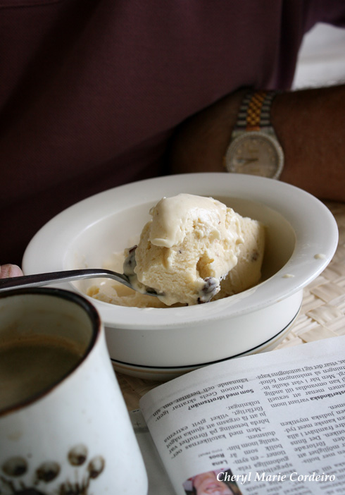 Homemade rum and raisin ice-cream, coffee and newspaper, Sweden in summer.