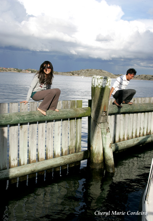 Cheryl and Nate, inching their way out to the end pole of the jetty fence, Swedish west coast.