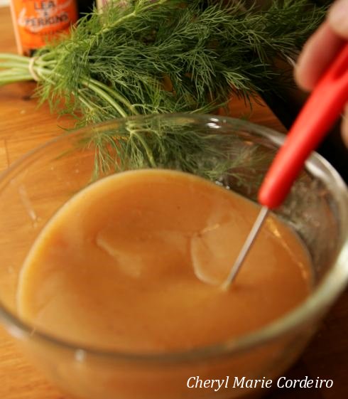 Stirring the mustard sauce to the gravlax.