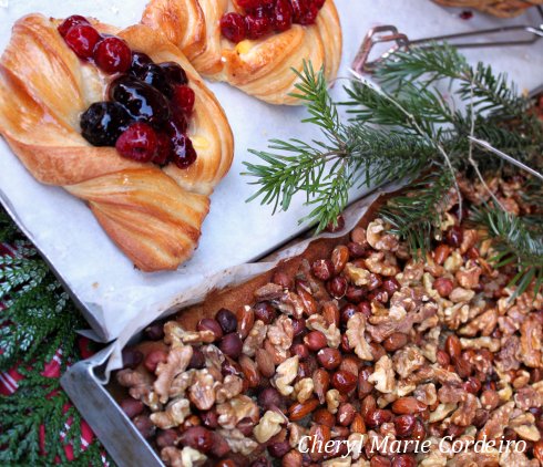 Danish pastry and a cake topped with caramelized nuts.